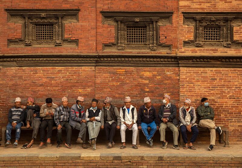 A group of men sit and chat in Kathmandu, Nepal. Kathmandu Valley has been experiencing record high levels of pollution in recent days. EPA