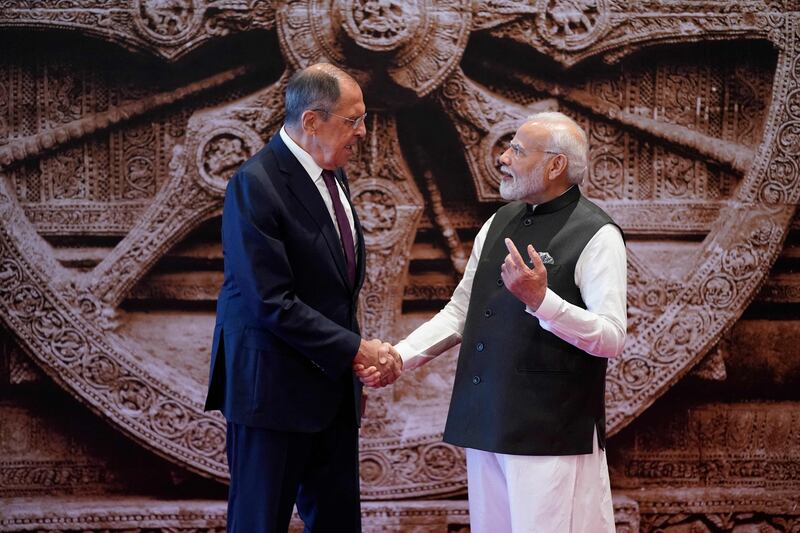 India's Prime Minister Narendra Modi greets Russian Foreign Minister Sergey Lavrov on the opening day of the G20 summit. AFP