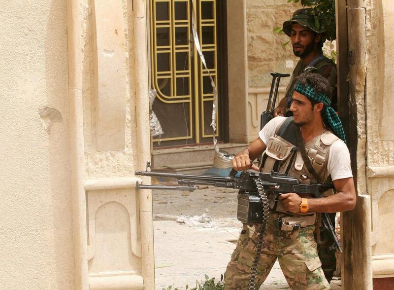 Shiite militia fighters supported by Iraqi security forces search homes looking for ISIL militants after regaining control of the town of Beiji on July 2, 2015. ISIL retaliated on Jul 6 with a number of suicide bomb attacks. AP Photo