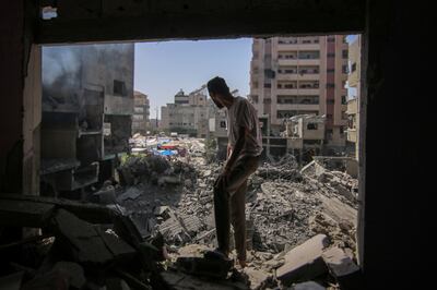 A Palestinian at the site of an Israeli strike on buildings in Nuseirat refugee camp. Bloomberg

