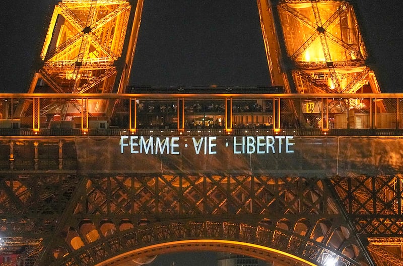 The Eiffel Tower lits the night with the a slogans "Woman, Life, Freedom" and "Stop Executions in Iran in support for the protests across Iran in Paris, Monday, January 16, 2023. AP