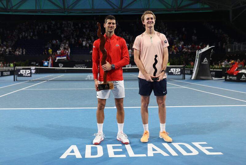 Novak Djokovic and Sebastian Korda pose with their trophies after the Adelaide International final. Reuters