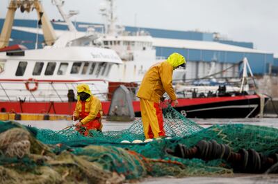 French fishermen repair their nets at Boulogne-sur-Mer, northern France. Photo: Reuters