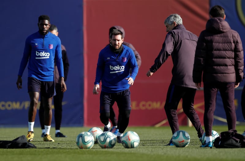 Lionel Messi, centre, takes part in a training session at Joan Gamper Sports City as Barcelona manager Quique Setien looks on. Reuters