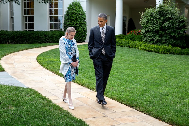 Mr Obama strolls the lawn with Supreme Court Justice Ruth Bader Ginsburg. Photo courtesy of former president