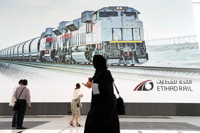 ABU DHABI,  UNITED ARAB EMIRATES , OCTOBER 6 – 2019 :- Delegates looking at the Etihad Rail poster during the 26th World Road Congress exhibition held at Abu Dhabi National Exhibition Center in Abu Dhabi. ( Pawan Singh / The National ) For News. Story by Patrick