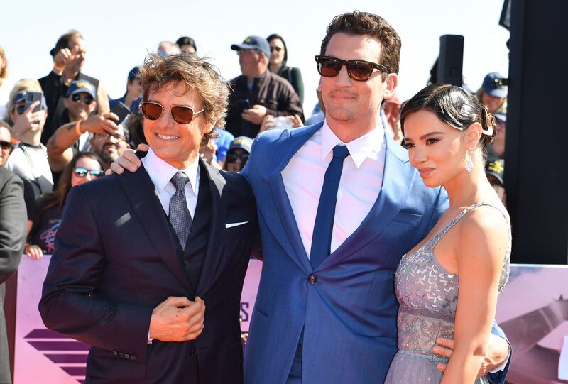Actors Tom Cruise, left, Miles Teller and his wife Keleigh Sperry. AFP