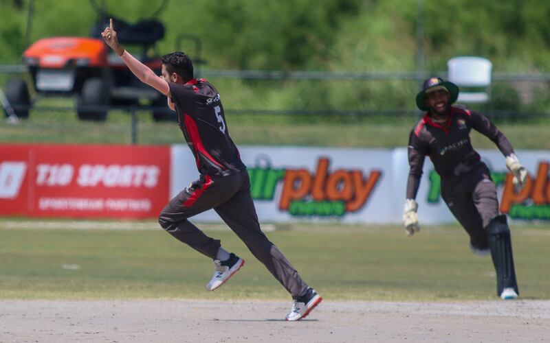 UAE pace bowler Akif Raja celebrates the wicket of United States opener Steven Taylor. 