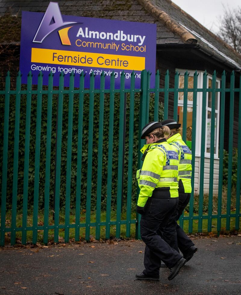 This Wednesday, Nov. 28, 2018 photo shows Police Community Support Officers walks outside Almondbury Community School in Huddersfield where a 16-year-old boy is to be charged with assault over an attack on a 15-year-old Syrian refugee. A Syrian refugee who was the victim of a lunchtime bullying incident widely shared on social media says he no longer feels safe at his U.K. school. (Danny Lawson/PA via AP)