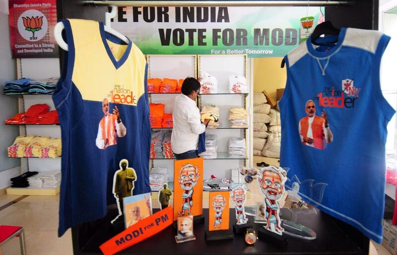 A visitor checks the publicity materials such as stickers, T-shirts, mugs and masks of Bharatiya Janata Party (BJP) Prime Ministerial candidate and Chief Minister of the Indian state of Gujarat, Narendra Modi in a showroom, in Bangalore. Jagadeesh NV / EPA