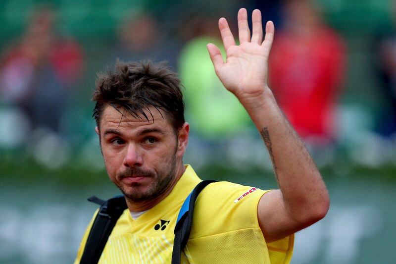 Stanislas Wawrinka waves to the crowd as he leaves the court following his first-round defeat at the French Open on Monday. Clive Brunskill / Getty Images / May 26, 2014 