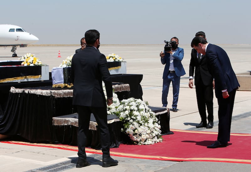 Mr Barzani attends the funeral ceremony at Erbil International Airport of those killed in the Dohuk attack. Reuters