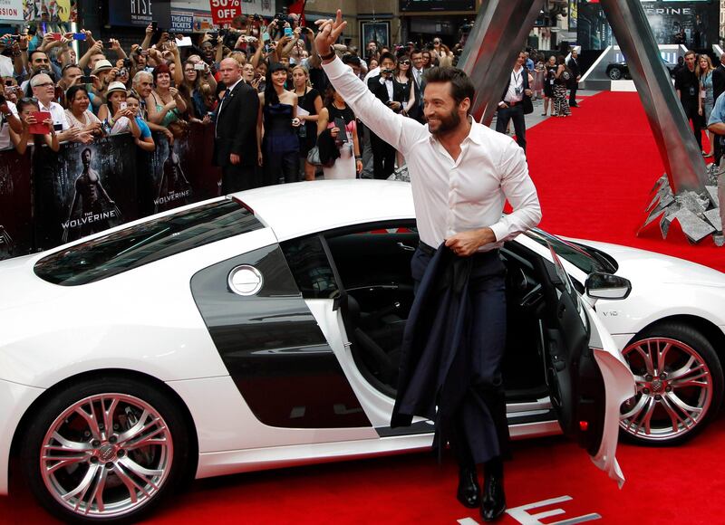 Actor Hugh Jackman waves as he arrives at the UK Premiere of "The Wolverine" at Leicester Square in London July 16, 2013. REUTERS/Luke MacGregor (BRITAIN - Tags: ENTERTAINMENT) *** Local Caption ***  LON106_BRITAIN-_0716_11.JPG