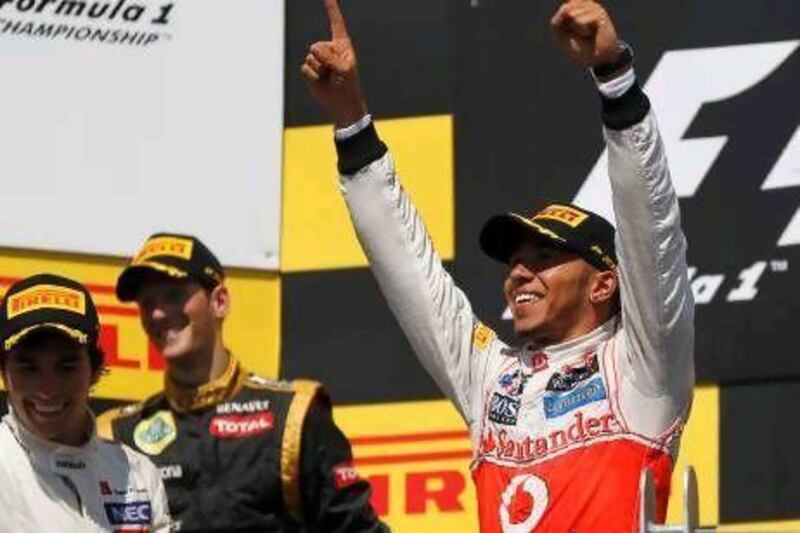 McLaren driver Lewis Hamilton, right, overcame bad pit stops to win for the first time on the 2012 season and make it seven different winners over the opening seven races.