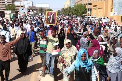 Supporters of deposed Sudanese president Omar al-Bashir rally after his conviction of graft near the presidential palace in the capital Khartoum, on December 14, 2019. Bashir, 75, was sentenced to two years house arrest in a social care facility, to be served after the verdict has been reached in another case accusing him of ordering the killing of demonstrators during the protests that led to his ouster, the judge said. / AFP / Ebrahim HAMID
