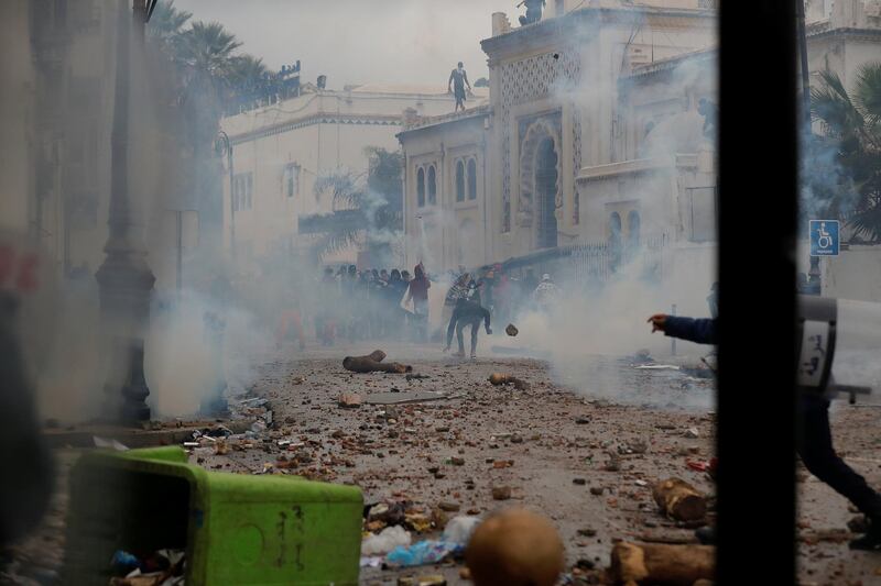 Anti-riot police officers clash with people protesting against President Abdelaziz Bouteflika, in Algiers. Reuters