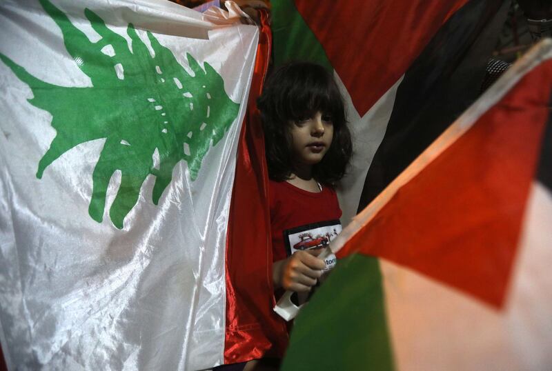 Palestinian family shows solidarity with Lebanon during the Solidarity Stand event held in Hebron. EPA