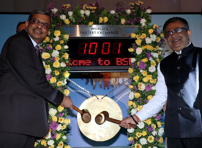 Life Insurance Corporation of India chairman M R Kumar and chief executive of the Bombay Stock Exchange, Ashishkumar Chauhan, hit the ceremonial gong during the company's listing ceremony in Mumbai, on Tuesday. Reuters