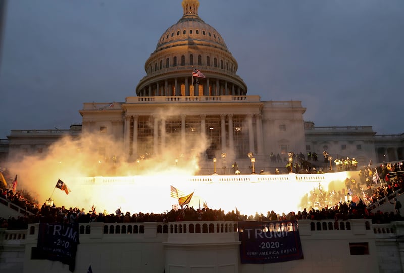 A police flash-bang blast lights up the Capitol. Reuters