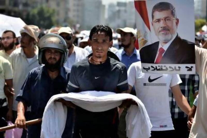 Egyptian supporters of deposed president Mohammed Morsi (on the poster) march during a demonstration against the government yesterday in Cairo.