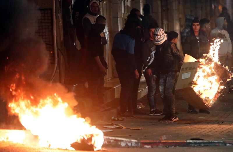 Palestinians build a burning barricade as they clash with Israeli security forces during a protest against US President Donald J. Trump's Middle East peace plan to solve the conflict between Palestinians and Israel, near the West Bank City of Hebron.  EPA