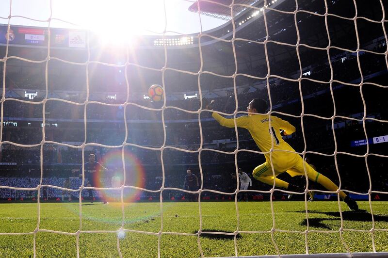 MADRID, SPAIN - DECEMBER 23: Lionel Messi of Barcelona scores his sides second goal past Keylor Navas of Real Madrid during the La Liga match between Real Madrid and Barcelona at Estadio Santiago Bernabeu on December 23, 2017 in Madrid, Spain.  (Photo by Denis Doyle/Getty Images)