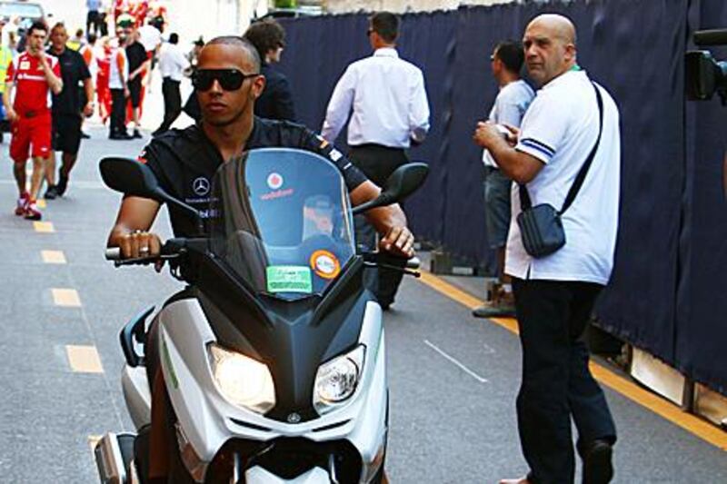 Lewis Hamilton drives through the Monaco paddock yesterday. The McLaren-Mercedes driver is confident of being able to challenge for victory in Sunday afternoon’s 78-lap race.