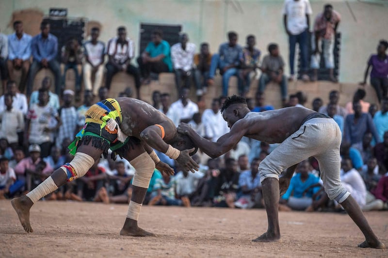 Wrestlers compete from teams of the Haj Youssef and Omdurman areas at a traditional Nuba wrestling competition in Sudan's capital Khartoum.