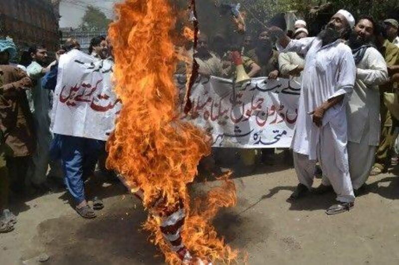 Pakistan Muthidda Shehri Mahaz activists burn the US flag during a protest in Multanagainst US drone attacks. Relations between the US and Pakistan is tense as Washington loses patience with Islamabad for not opening Nato supply routes.