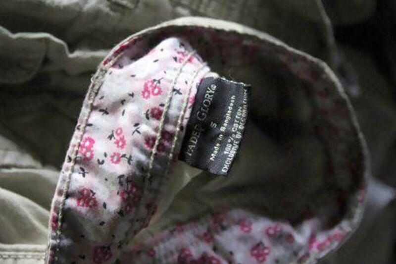 Walmart's Faded Glory label can be seen on a piece of clothing lying among equipment charred in the fire that killed 112 workers at the Tazreen Fashions factory, on the outskirts of Dhaka.