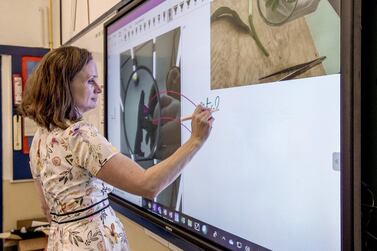 Physics teacher Regina O'Dwyer demonstrates the virtual classroom. Victor Besa/The National