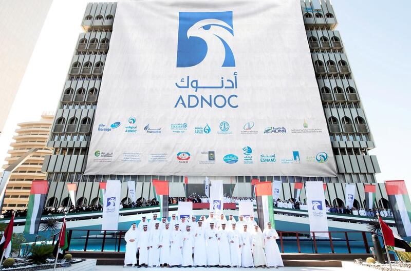 Above, officials and staff led by chief executive Sultan Al Jaber during Sunday’s unveiling of the Adnoc’s new branding. Courtesy of Adnoc