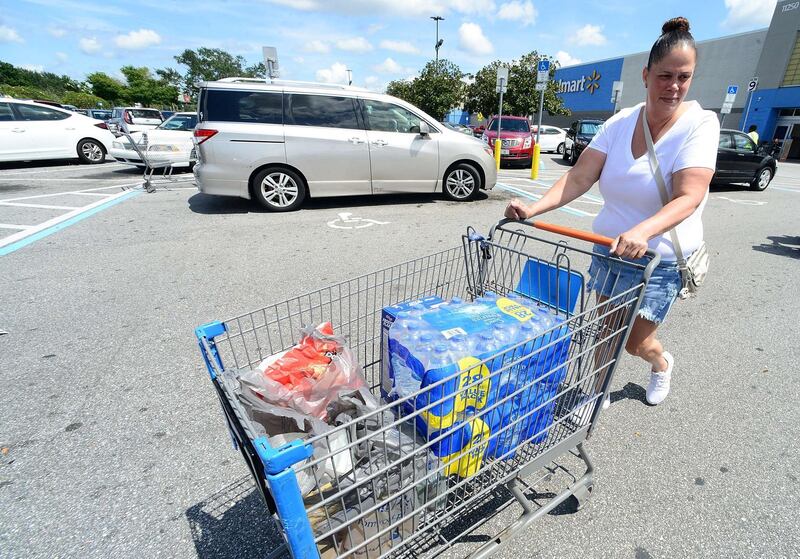 Sheila Guerra wheels groceries to her car at a Wal-Mart Super Store in Orlando. AFP