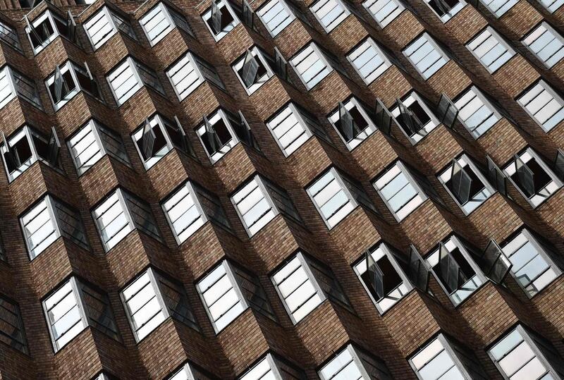 Windows are opened in a high rise building as mild spring weather arrives in Sydney. AFP