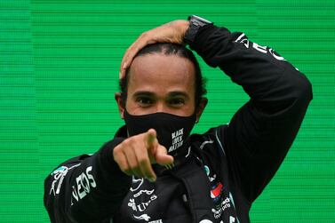 FILE PHOTO: Formula One F1 - Portuguese Grand Prix - Algarve International Circuit, Portimao, Portugal - October 25, 2020 Mercedes' Lewis Hamilton celebrates winning the race on the podium Pool via REUTERS/Rudy Carezzevoli/File Photo