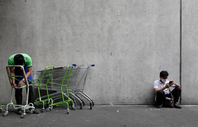 A man wears a mask outside a supermarket in Manila. AP