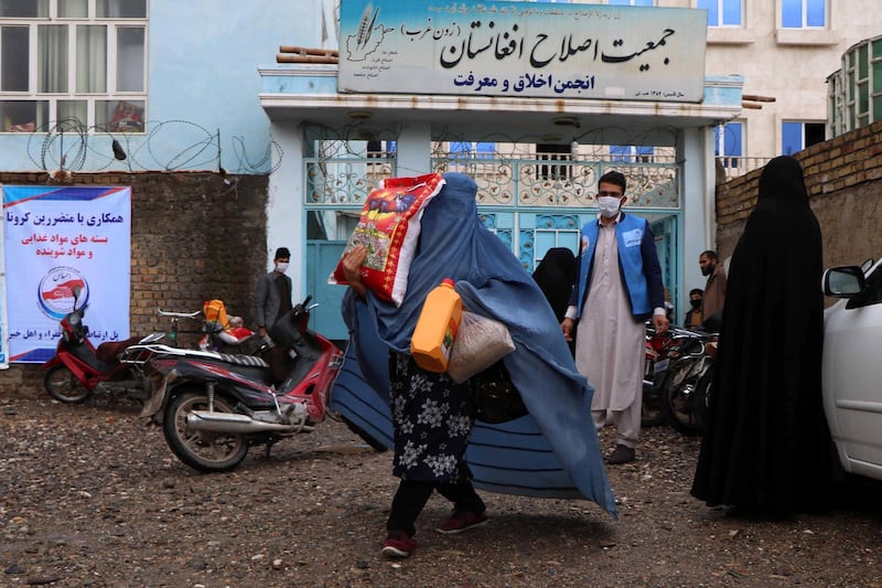 Afghan women receive free rations distributed in Herat, Afghanistan, on March 24, 2020. EPA