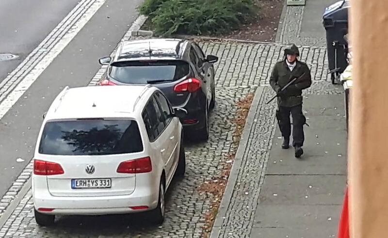 Neo-Nazi Stephan Balliet walks down the street with a rifle during the attack. EPA