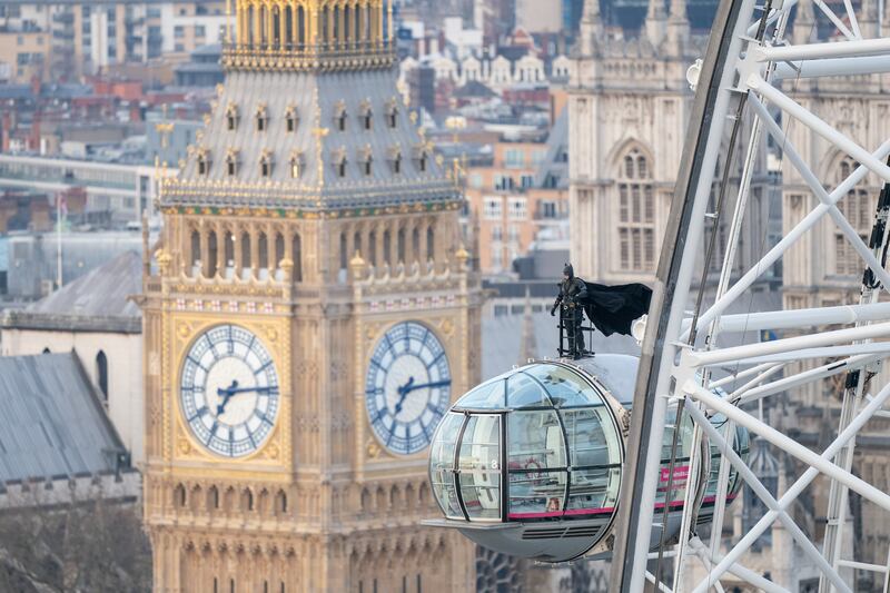 A man dressed as Batman stands on top of the London Eye before the release of 'The Batman' in UK cinemas on March 4. AP