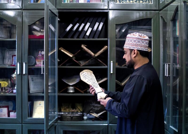 MUSCAT, SULTANATE OF OMAN. 14  JANUARY 2020.
Salem Al Jadidi, 30, works on palm seed germination in a govermental office in Bahla. He is a collector of printed archives relating to Oman. He holds a bone with Arabic text that belonged to his uncle. This was used in schools, where paper was not in abundance, and the cirriculam was written on ox or camel bones.

Oman is observing a three-day mourning period following the passing of His Majesty Sultan Qaboos bin Said. Today marks the third day of mourning.

(Photo: Reem Mohammed/The National)

Reporter: ANNA ZACHARIAS
Section: NA