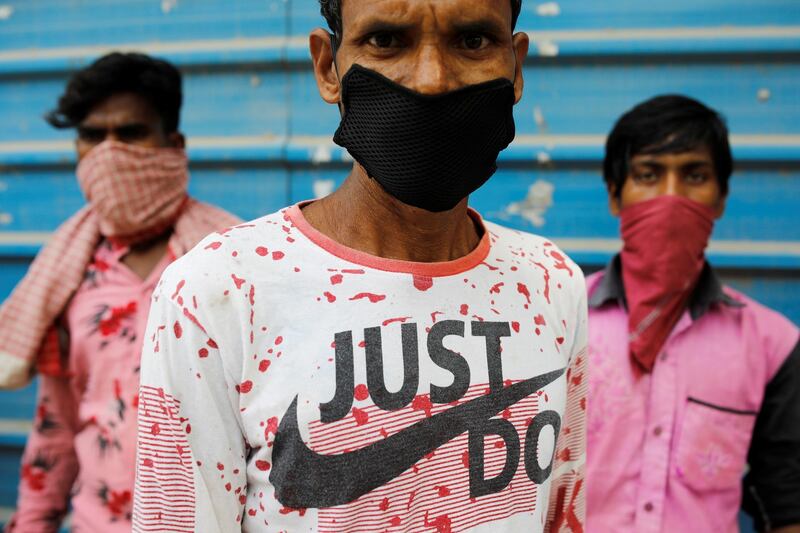 Migrant laborers wait for a rapid antigen test at the site of an under construction residential complex in New Delhi, India. Reuters