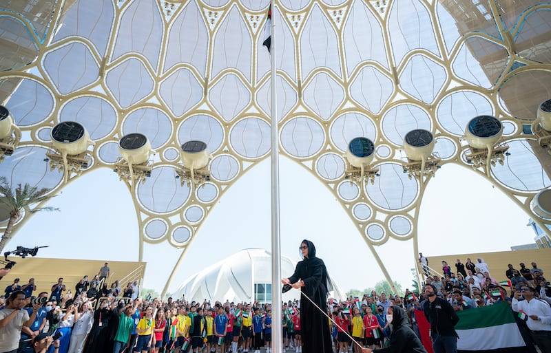 Reem Al Hashimy, Minister of State for International Co-operation, raises the UAE flag at Expo City Dubai. Photo: Expo City Dubai