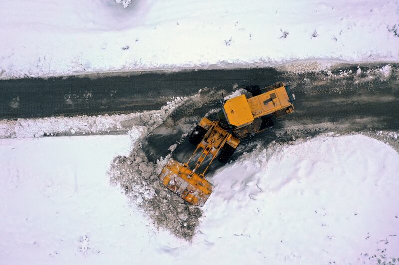 A bulldozer clears a road in Salat Zagrous. Access to the camp was cut off by the bad weather, the UN co-ordinator said