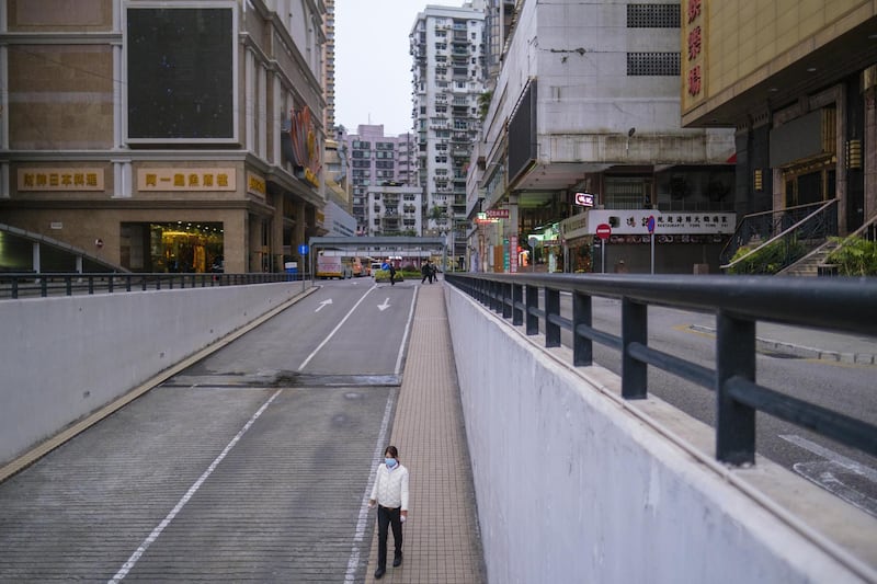 A pedestrian walks into a tunnel in Macau, China. Bloomberg