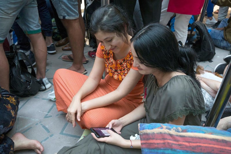 <p>Apple customers queue through the night to be one of the first to get the new Apple devices. Leslie Pableo&nbsp;/ The National</p>
