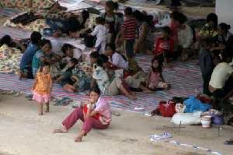 Refugees from Kokang, in Myanmar's Shan State, rest at a temporary shelter at the border town of Nansan, China's Yunnan province, August 31, 2009. Refugees who fled to China from armed clashes in northeast Myanmar began going back on Monday, overcoming worries about safety to return to shops and homes they feared would be looted.  Picture taken August 31, 2009. REUTERS/Stringer (CHINA CONFLICT POLITICS) CHINA OUT. NO COMMERCIAL OR EDITORIAL SALES IN CHINA *** Local Caption ***  PEK04_CHINA-MYANMAR_0901_11.JPG