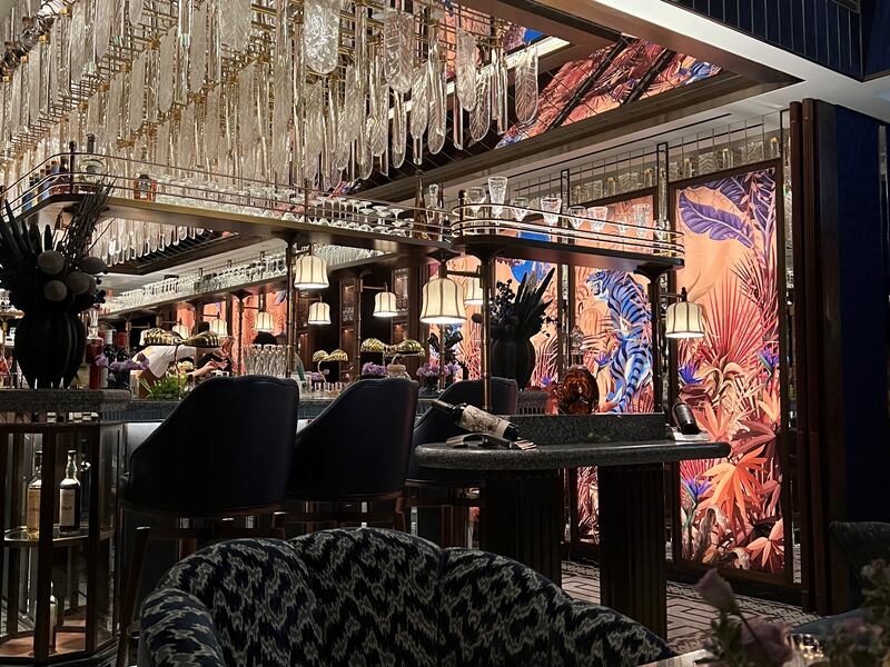 The bar features chandelier ceilings and a colourful mural. Sophie Prideaux / The National