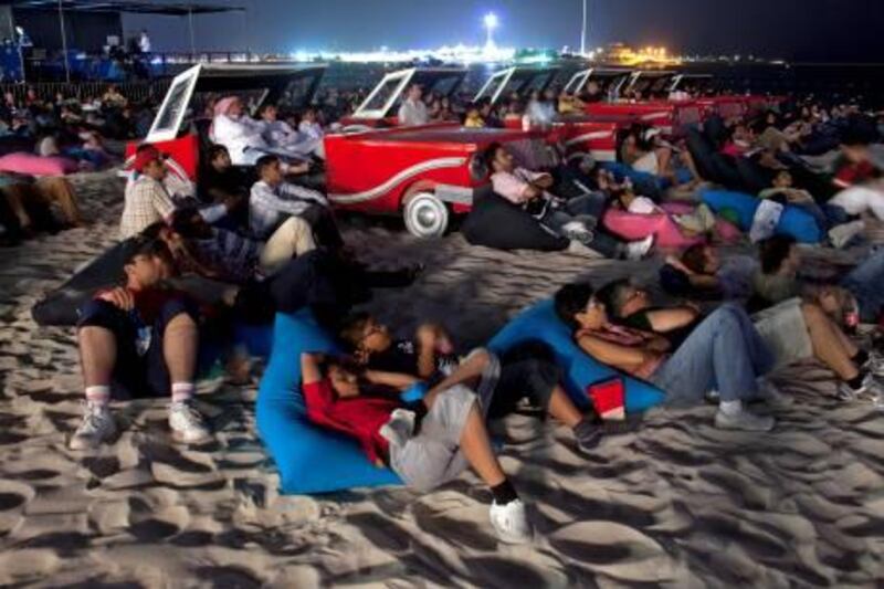 Abu Dhabi, October 29, 2010 - Visitors to the FanZone watch the movie "Knight Rider" on the Corniche during the Cinema by the Sea event, part of Yasalam in Abu Dhabi, October 29, 2010. (Jeff Topping/The National) 