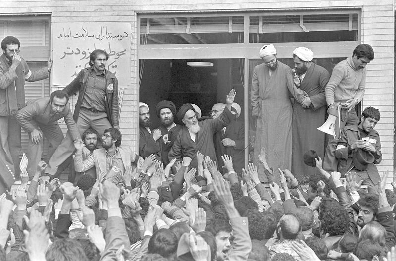 FILE - In this Feb. 1, 1979 file photo, Ayatollah Ruhollah Khomeini, center, waves to followers as he appears on the balcony of his headquarters in Tehran, Iran. Friday, Feb. 1, 2019 marks the 40th anniversary of Khomeini's arrival in Iran, setting the stage for the country's 1979 Islamic Revolution that changed the country‚Äôs history for decades to come. (AP Photo/Campion, File)