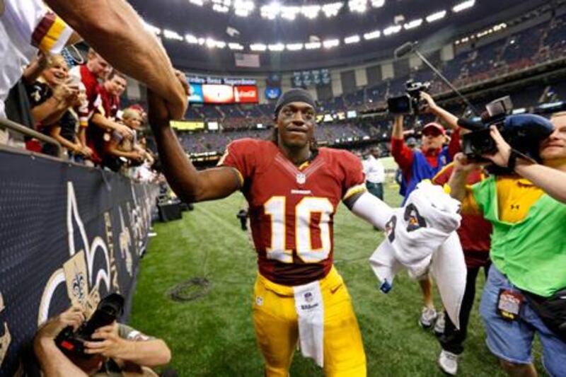 Washington Redskins quarterback Robert Griffin III is congratulated by fans after his side's win over the New Orleans Saints